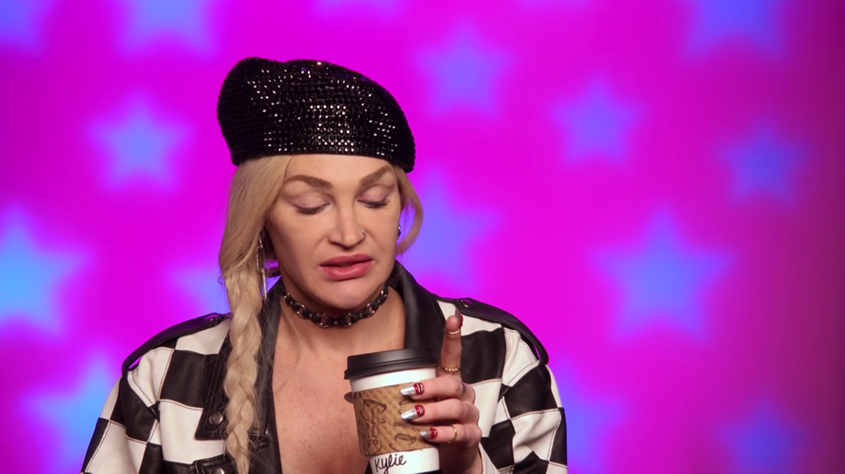 Kylie looking at her coffee.
