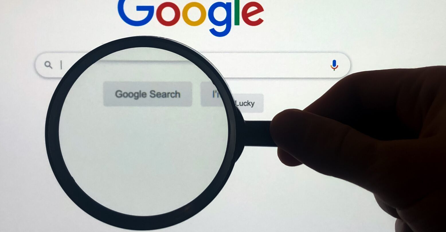 Google search engine page view through magnifying glass loupe
