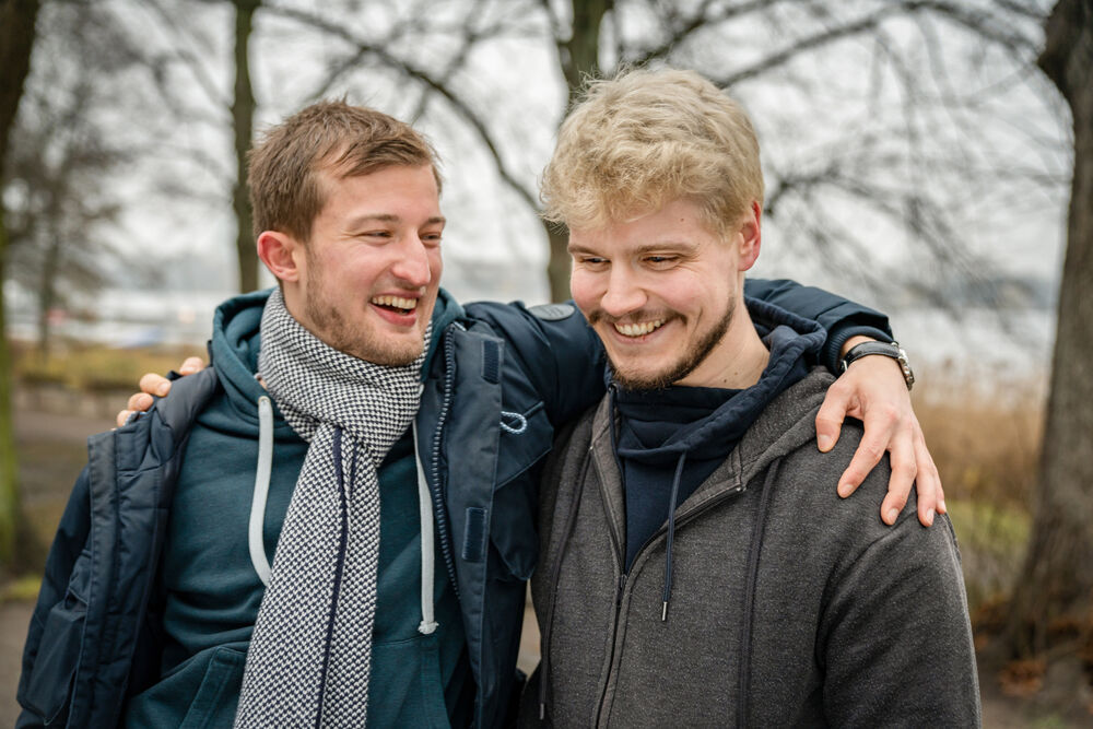 Two men standing with arms around one another at a park in Hamburg, Germany, the man on the right is living with HIV