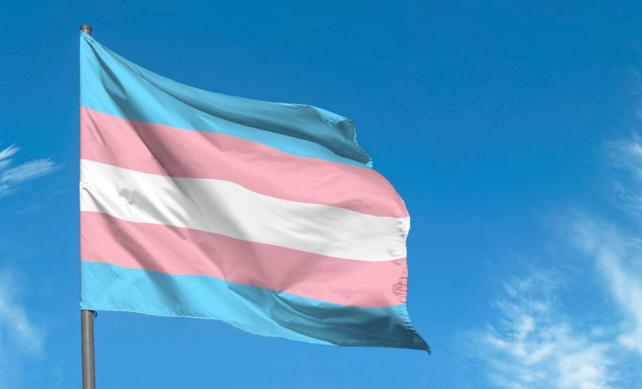 My boyfriend discovered I'm trans: An image of the transgender flag waving against a bright, blue sky.