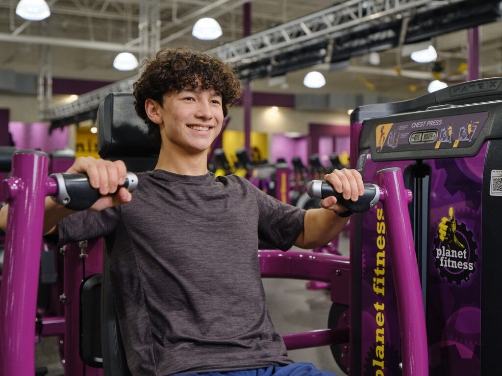 A teen working out at Planet Fitness.